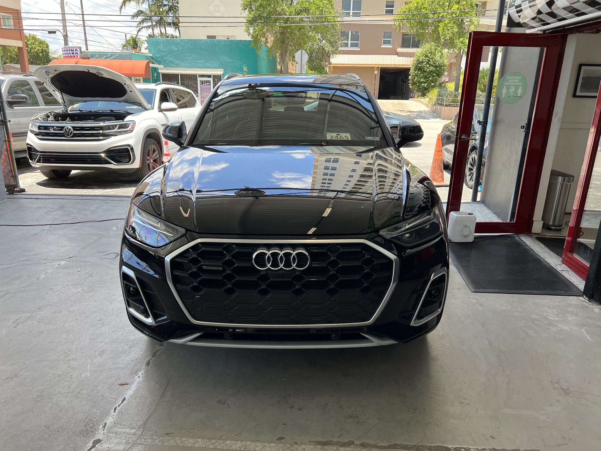 Audi vehicle entering repair shop for service in Miami, Fl