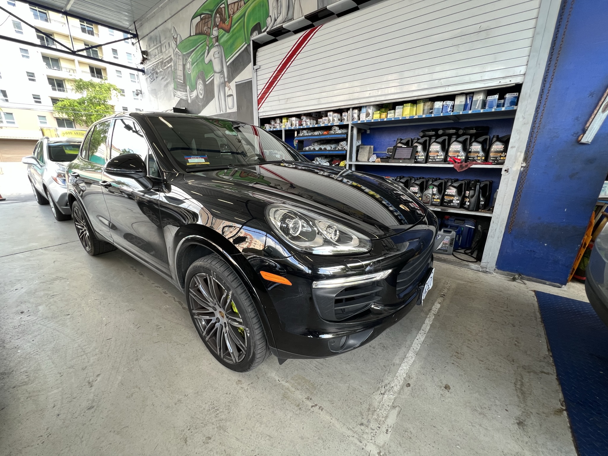 Porsche Cayenne entering the shop for automotive repair 