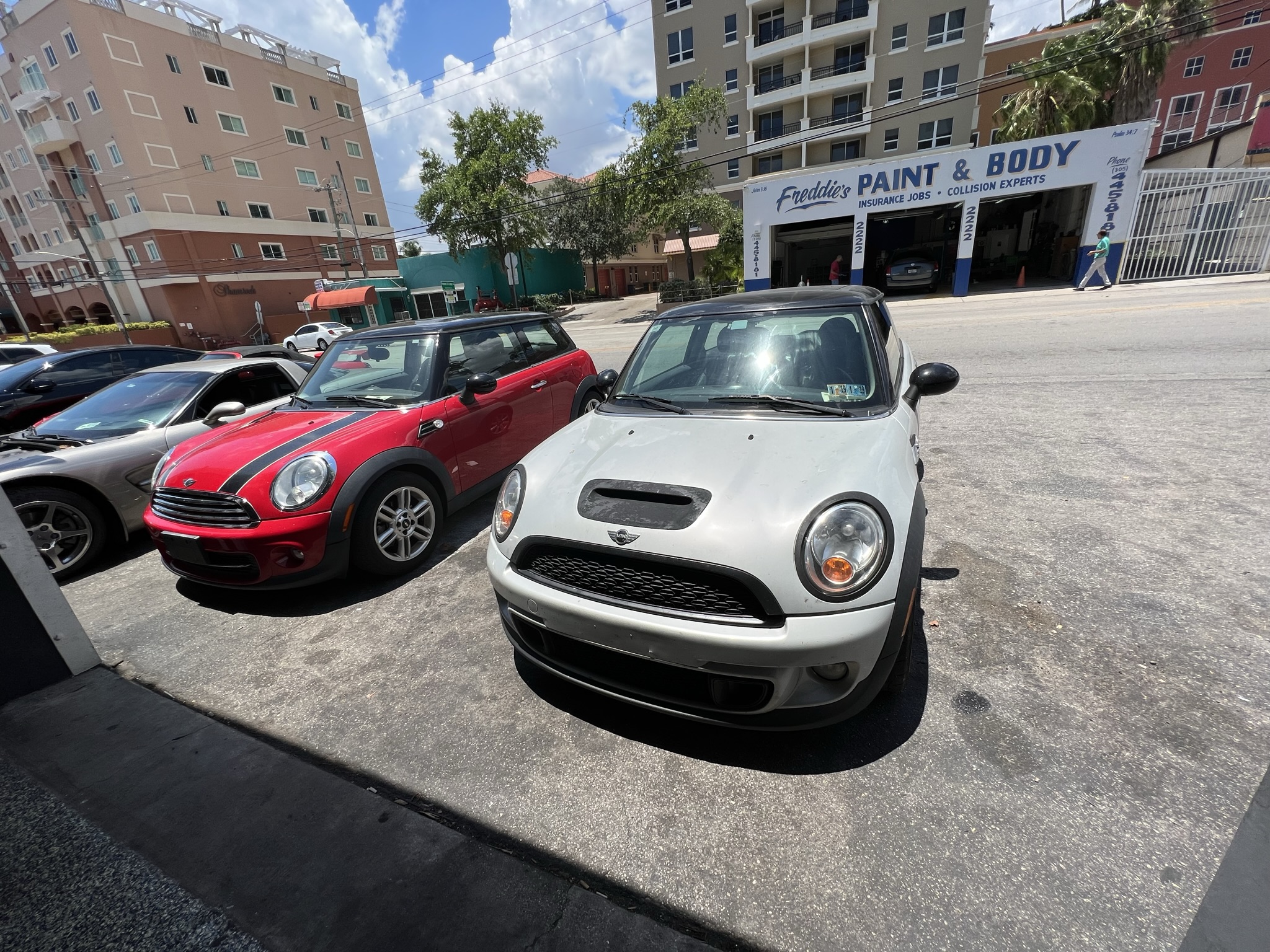 A red and a white MINI at the shop for automotive repair